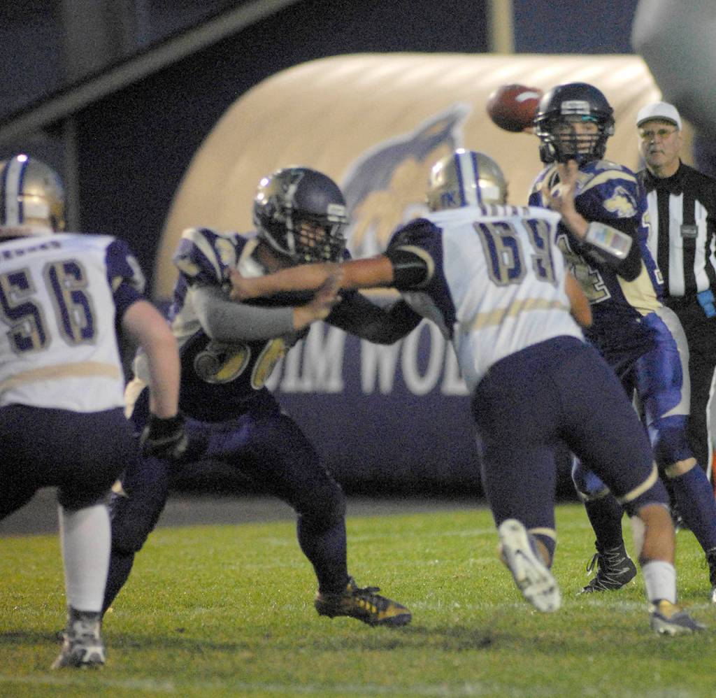 Sequim junior Riley Cowan (with ball) returns for his third season as the Wolves&rsquo; starting quarterback.