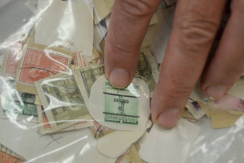 Dan Brooks of Port Angeles points out a precanceled stamp, a stamp that was canceled before being placed on mail, in a small collection for the Strait Stamp Society&rsquo;s annual show Saturday. He began collecting these stamps again in the past year after discovering his junior high stamp collection. (Matthew Nash/Olympic Peninsula News Group)