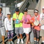 Bob Sester and Beverly Hoffman, both of Sequim, center, in yellow and pink, celebrate winning gold in the mixed doubles 70-plus division at the Senior Games in Auburn July 21-23.