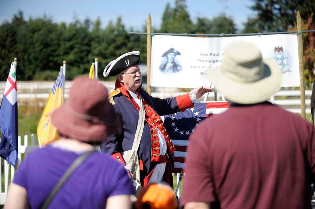 Doug Nelson of Poulsbo with the Sons of the American Revolution talks about Betsy Ross&rsquo; flag to visitors of the Northwest Colonial Festival in 2016. (Matthew Nash/Olympic Peninsula News Group)