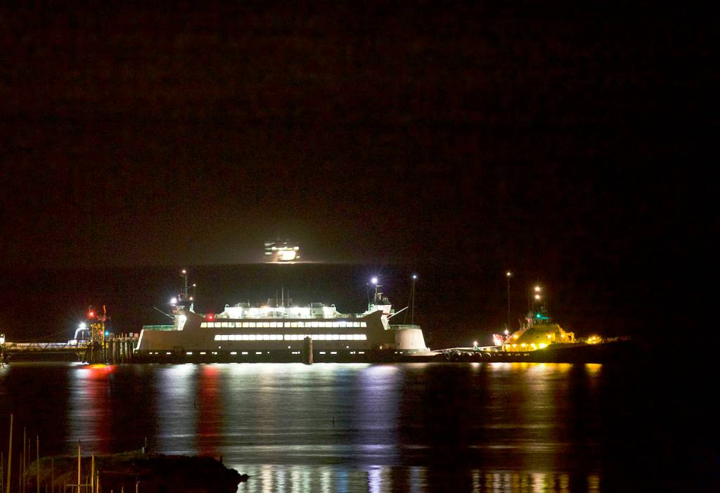 Steven Mullensky/for Peninsula Daily News                                The MV Salish is hooked up to a tug late Friday night in order to be towed to a repair facility after running aground while approaching Keystone Harbor last Tuesday.