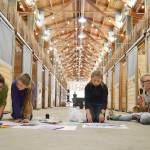 Members of the Silver Spurs 4-H Club &mdash; from left, Ashlyne Money, 16; Sierra Steffen, 12; Marissa Steffen, 10; and Lisi Hanson, 15 &mdash; design posters for their horses&rsquo; stalls Monday in a horse barn at the Clallam County Fairgrounds. Their group will show 18 horses throughout the fair, which runs through Sunday. (Matthew Nash/Olympic Peninsula News Group)