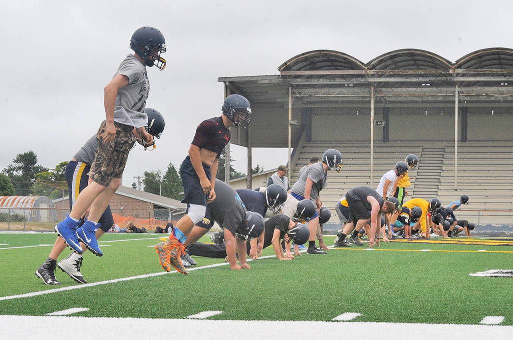 Lonnie Archibald/for Peninsula Daily News                                Members of the Forks football team jump for joy as they go through conditioning during the first day of practice Wednesday at Spartan Stadium.
