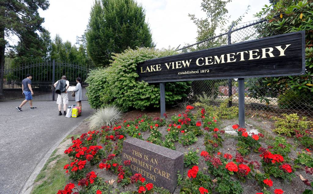 People gather at the locked gates of Lake View Cemetery in Seattle, which was closed Thursday following angry messages they&rsquo;ve received over a memorial for Confederate soldiers there. (Elaine Thompson/The Associated Press)