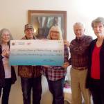 Ed Veraldi of Sequim Aeronauts and Bonnie Williams of the Olympic RC Modelers present a check for $4,174 to Bette Wood, Dave Gilbert and Lynn Gilbert of Volunteer Hospice of Clallam County &mdash; proceeds from the RC airplane demonstration and raffle held at the 2016 Air Affaire.