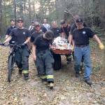 Clallam County Fire District No. 2 crew members help transport a bicycle accident victim out of the woods off Dry Hill, up Walkabout Way Road off U.S. Highway 101 near Port Angeles. (Clallam County Fire District No. 2)