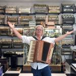 One of the festival organizers Paul Rogers poses in Petosa Accordions, an accordion shop and museum in Seattle. (Paul Rogers)