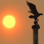 Keith Thorpe/Peninsula Daily News The sun shines behind a flagpole in front of the Clallam County Courthouse in Port Angeles at mid-morning on Tuesday as layers of smoke from wildfires in eastern Washington and Montana filter the light to shades of orange and red.