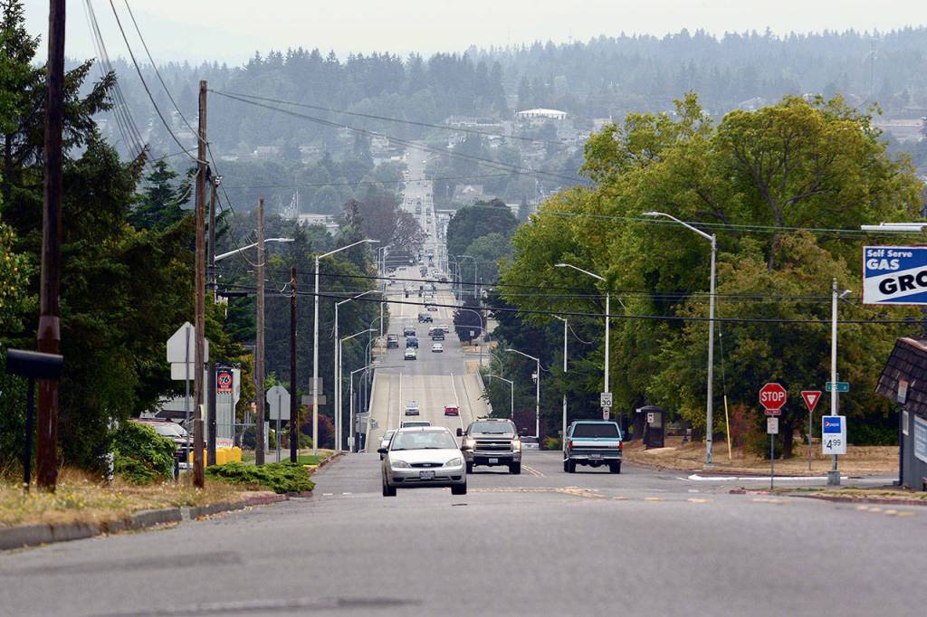 Traffic travels on Eighth Street in Port Angeles on Tuesday as smoke from wildfires across the state settles over the region. (Jesse Major/Peninsula Daily News)