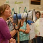 Nikki Russell of Port Townsend leads more than 50 people in a chant for unity at a protest at Adams Street Park in Port Townsend against the Trump administration&rsquo;s announcement moving to end the Deferred Action for Childhood Arrivals program. (Cydney McFarland/Peninsula Daily News)