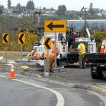 A Port Angeles Street Department crew removes a section of mangled guardrail near the Valley Creek Estuary along First Street after it was struck by a car early Friday morning. (Keith Thorpe/Peninsula Daily News)