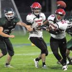 Port Townsend&rsquo;s Jacob Boucher, right, watches as the ball gets away from him after an interrupted handoff from quarterback Noa Apker-Montoya, center, prompted by the defensive work of Port Angeles&rsquo; Bryce Lauderback, left, in the second quarter on Friday at Port Angeles Civic Field.                                Keith Thorpe/Peninsula Daily News