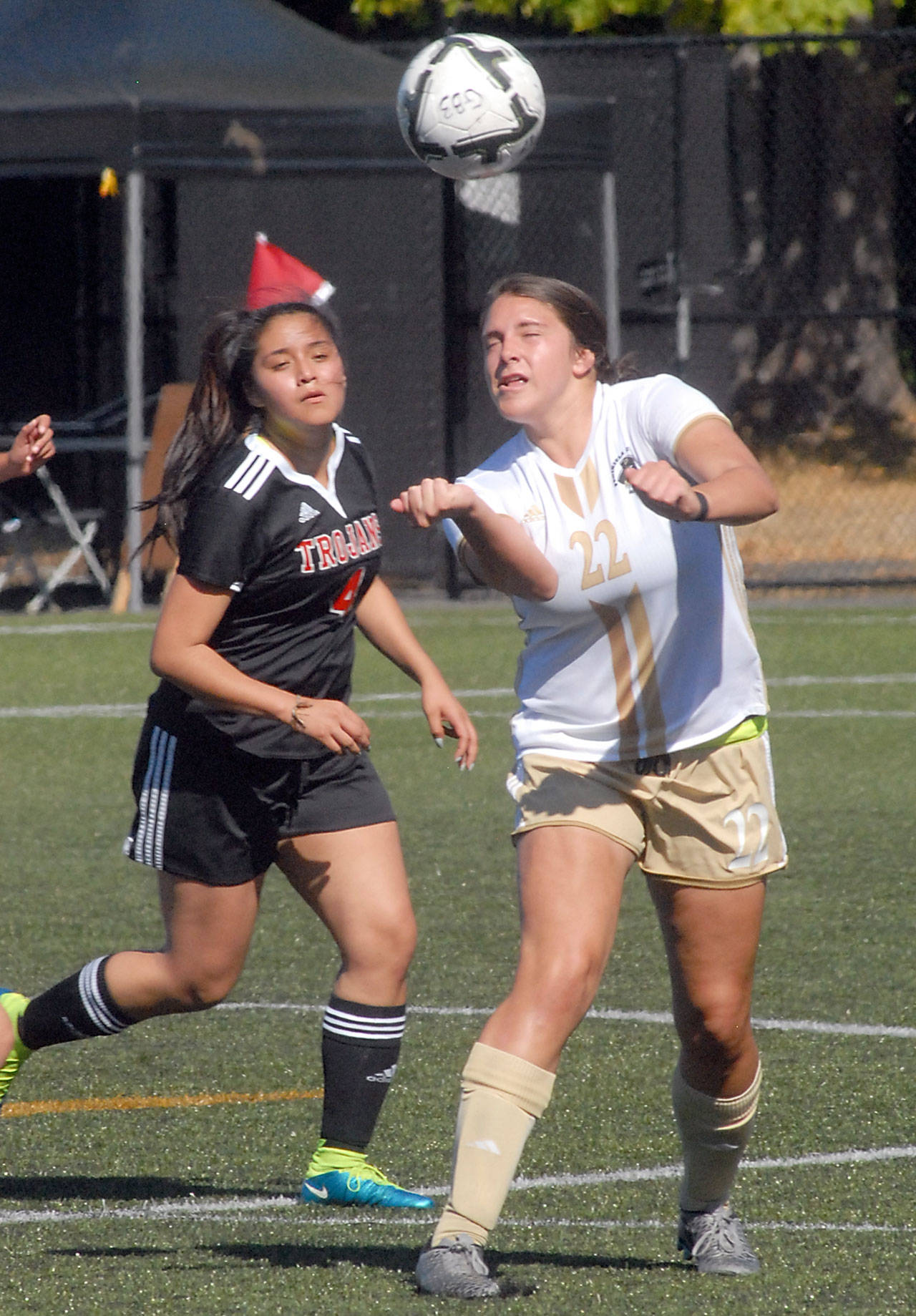Peninsula&rsquo;s Samantha Guzman, heads the ball as Everett&rsquo;s Stephanie Herrera defends during the first half on Wednesday at Wally Sigmar Field in Port Angeles. Keith Thorpe/Peninsula Daily News