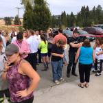 Parents gather in the parking lot behind Freeman High School in Rockford to wait for their kids after a deadly shooting at the high school Wednesday. (Dan Pelle/The Spokesman-Review via AP)