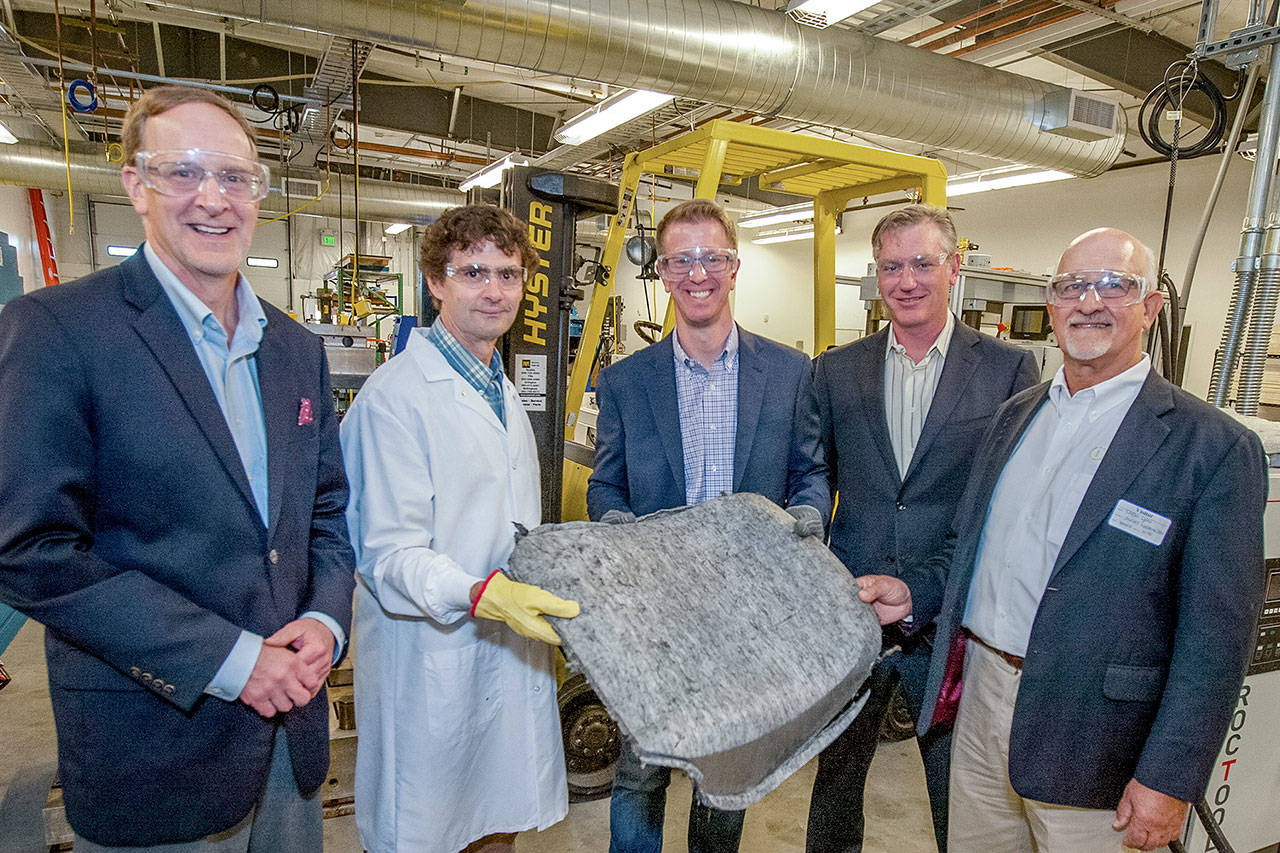 From left, Composite Recycling Technology Center Chief Executive Officer David Walter; Geoffrey Wood, CRTC fellow and vice president of innovation; U.S. Rep. Derek Kilmer; Brian Young, state Department of Commerce Clean energy sector lead; and Loren Lyon, president and center director of Impact Washington, stand together around a seat back preform Aug. 8.