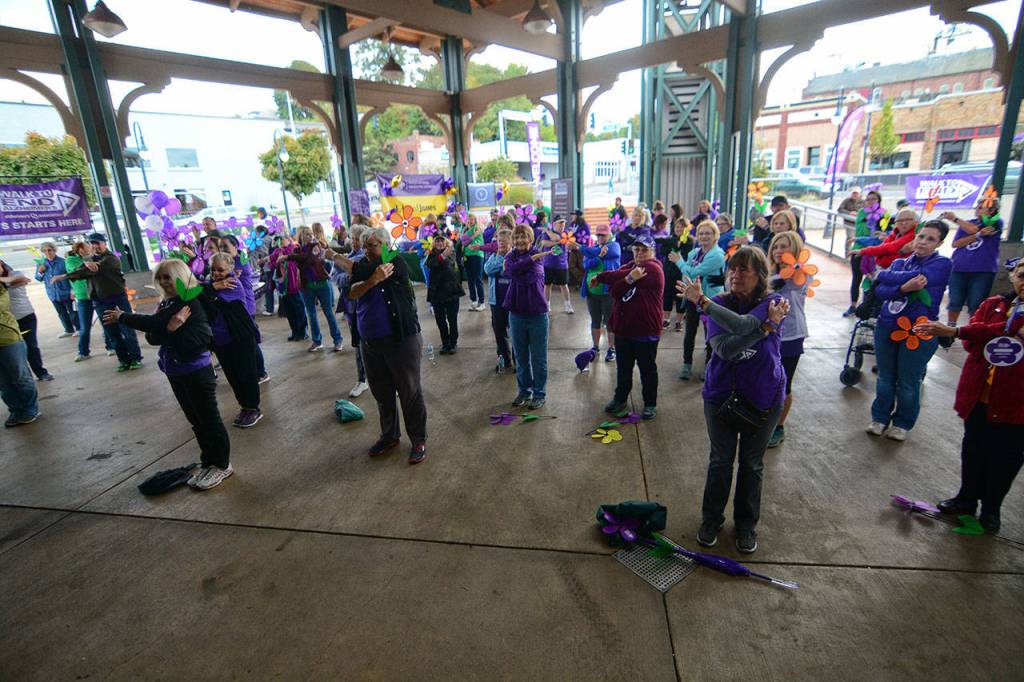Participants in the Walk to End Alzheimer&rsquo;s stretch before the the walk in Port Angeles on Sunday. (Jesse Major/Peninsula Daily News)