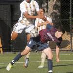 Peninsula&rsquo;s Sterling Penniston-John, left, goes up and over Whatcom&rsquo;s Keegan Coovert during the first half on Wednesday in Port Angeles, In the background is Penniston-john&rsquo;s teammate Calvin Aguirre.                                Keith Thorpe/Peninsula Daily News