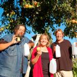 Coordinators of the eighth annual Apple Stock benefit &mdash; Jonathan Simonson, Kelly Sanders and Mark Schwartz, from left &mdash; prepare to press organic apples into cider Oct. 6-8. The three-day event features music, cider pressing and concessions, with donations going toward local causes. (Erin Hawkins/Olympic Peninsula News Group)