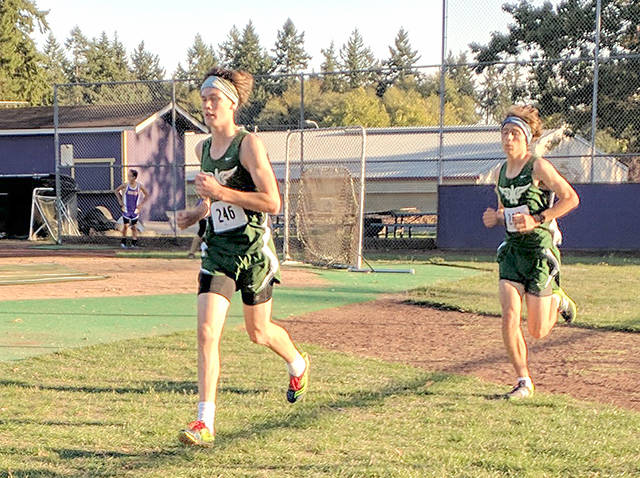 Port Angeles junior Gabe Long (front) and sophomore Thomas Shaw turn on the speed during the third mile of their cross country meet at North Kitsap High School.                                Port Angeles Cross Country