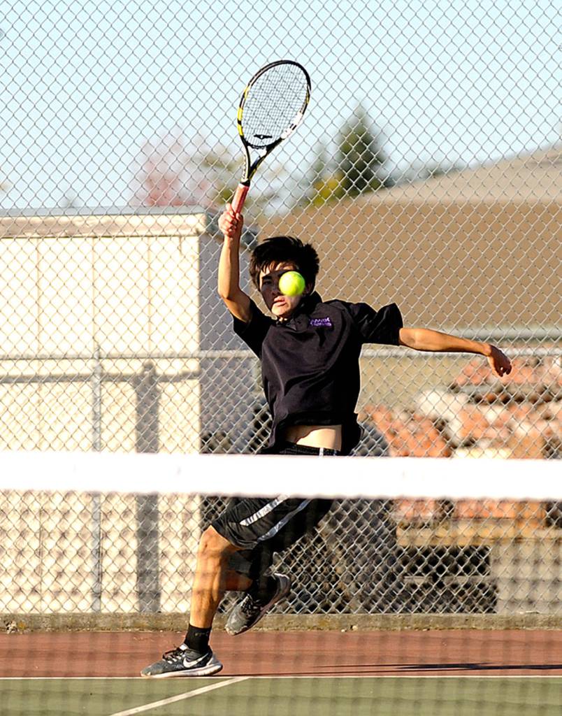 Sequim&rsquo;s Raymond Lam looks to return a serve as he takes on Port Angeles&rsquo; Kenny Soule on Thursday. (Photo by Michael Dashiell/Olympic Peninsula News Group)