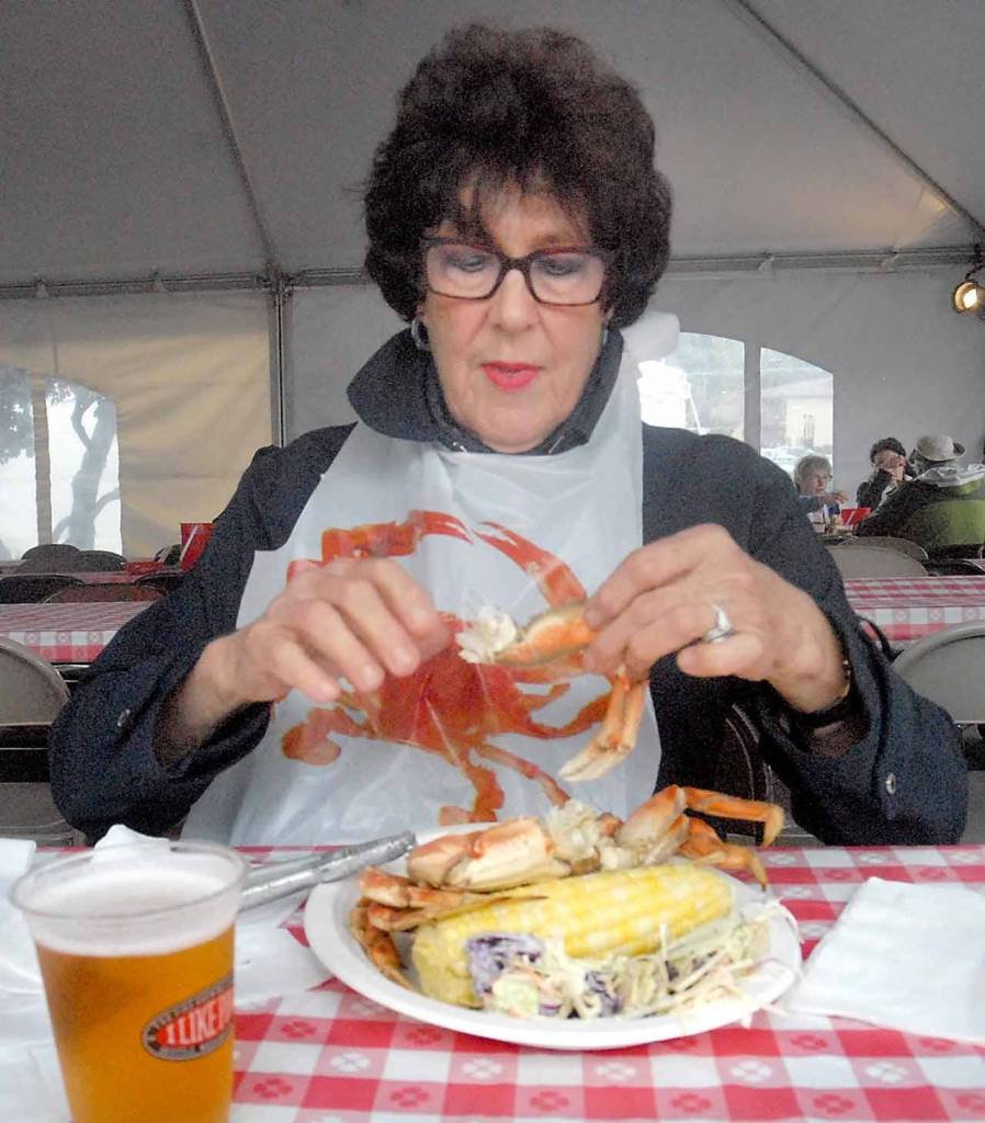 Dorothy Moran of Victoria enjoys a crab dinner at the Dungeness Crab & Seafood Festival. (Keith Thorpe/Peninsula Daily News)