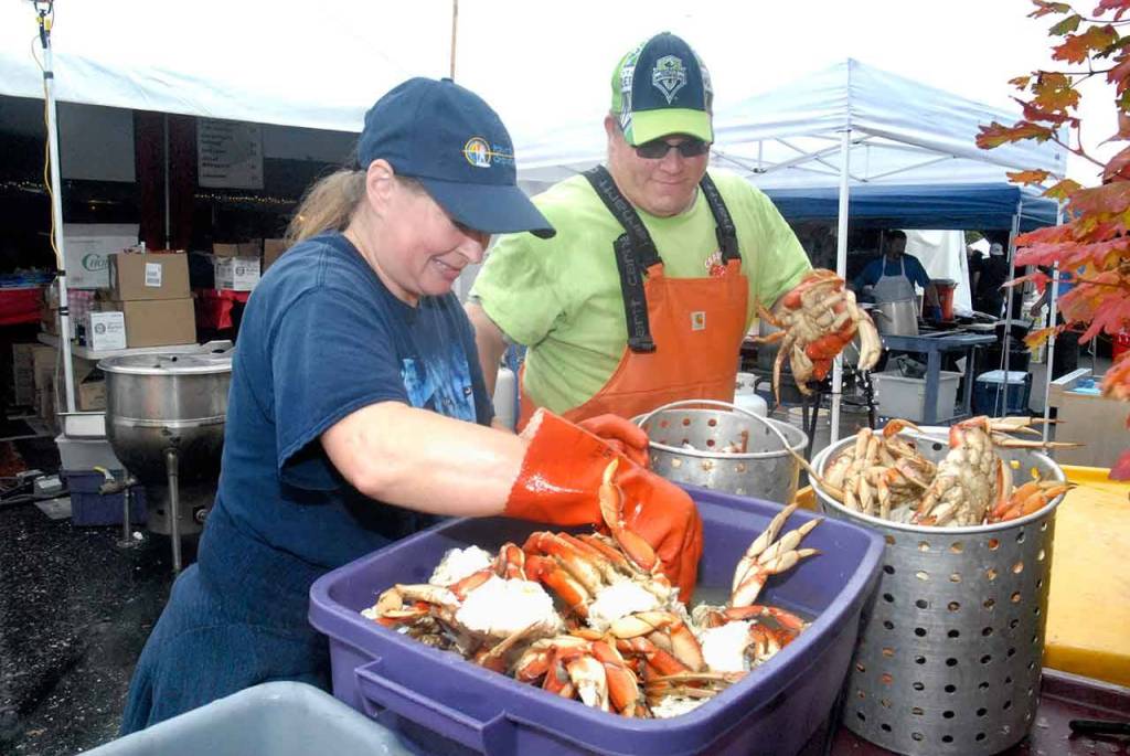 Crab Crew members Angela Atwood, left, and Jacob Brown, both of Port Angeles, work behind the scenes to prepare crab for cooking at the Dungeness Crab & Seafood Festival. (Keith Thorpe/Peninsula Daily News)