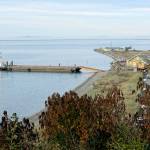 A barge delivered a 1916 Sears kit house to Cline Spit on Monday. Crews from Nickel Bros. helped unload the house, purchased by Jim and Diane Luoma and moved from Shelton. (Steve Jones )