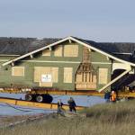 Crews from Nickel Bros. help unload a 1916 Sears kit house off a barge onto Cline Spit on Monday. Jim and Diane Luoma bought the house and moved it from Shelton. (Steve Jones)