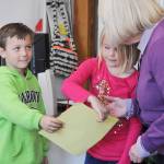 Greywolf kindergartners Aidan Pederson and Katelyn Dickinson give U.S. Sen. Patty Murray a card during Murray&rsquo;s school visit Oct. 11. (Michael Dashiell/Olympic Peninsula News Group)