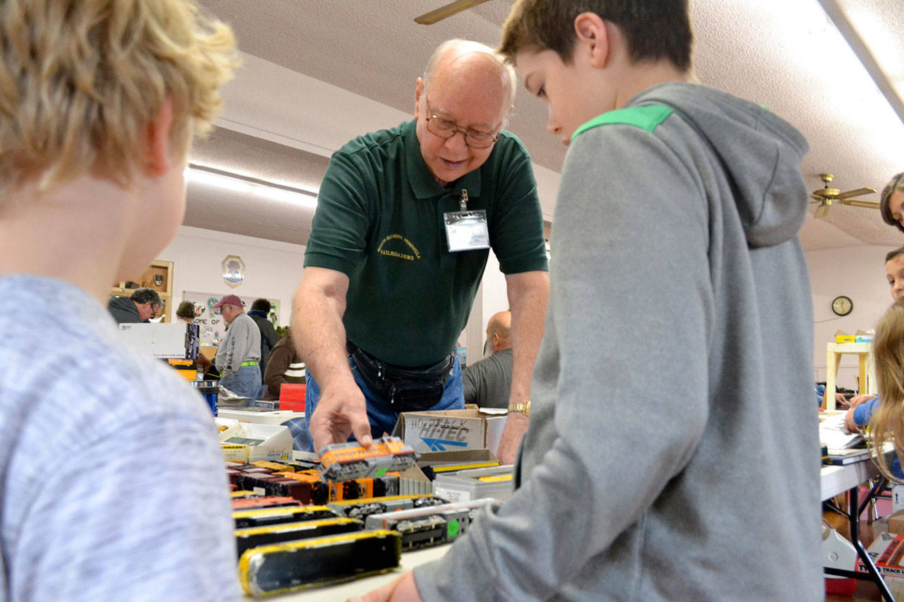 Richard Bell with the North Olympic Peninsula Railroaders speaks with brothers Ben and Jack Clemens of Port Angeles at the club&rsquo;s annual Trains Show and Swap Meet last year. The show continues this Saturday and Sunday at the Sequim Prairie Grange. (Matthew Nash/Olympic Peninsula News Group)