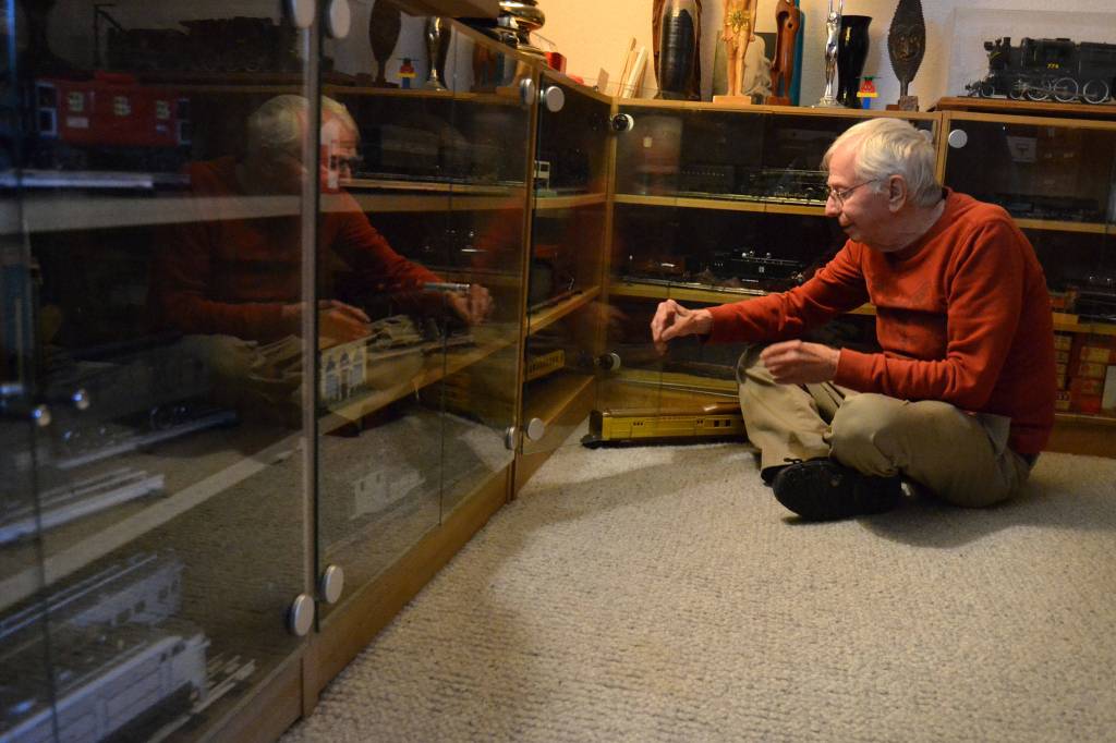 Pat Furey of Sequim sits with some of his train collection, including a 1935 Lionel Union Pacific Passenger train. Furey said he grew up in New York and used to visit the big train displays at Christmastime and be &ldquo;wowed.&rdquo; (Matthew Nash/Olympic Peninsula News Group)