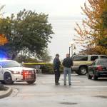 Port Angeles Police Officer T.J. Mueller talks with a passer-by near the scene of where the body of a woman was found on the Olympic Discovery Trail at 9/11 Memorial Waterfront Park on Thursday in Port Angeles. (Keith Thorpe/Peninsula Daily News)