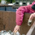 Patricia Moreland drops off glass bottles at the recycle drop site outside of the solid waste disposal facility in Port Townsend. (Cydney McFarland/Peninsula Daily News)