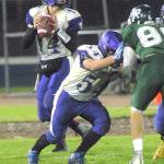 Sequim quarterback Riley Cowan, left, drops back to pass as teamate Adam DeFillipo blocks Port Angeles&rsquo; Dominick Timperio during their matchup last week at Port Angeles Civic Field.                                Keith Thorpe/Peninsula Daily News