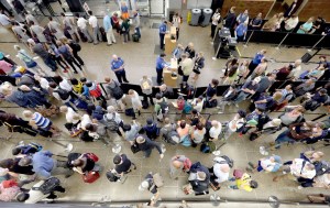 Travelers wait in long security lines at Seattle-Tacoma International Airport earlier this month. The Associated Press