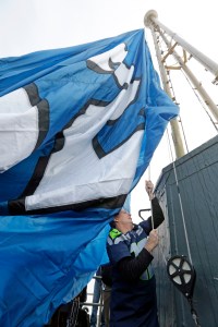 Pearl Jam lead guitarist Mike McCready raises a "12th Man" flag atop the Space Needle on Friday. (The Associated Press (Click on photo to enlarge))
