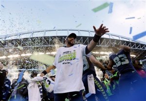 Seattle Seahawks' Russell Wilson celebrates after overtime of the NFL football NFC Championship game against the Green Bay Packers. (The Associated Press)