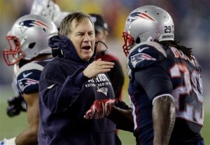 New England Patriots head coach Bill Belichick congratulates LeGarrette Blount after his touchdown during the second half of the NFL football AFC Championship game against the Indianapolis Colts. (The Associated Press)