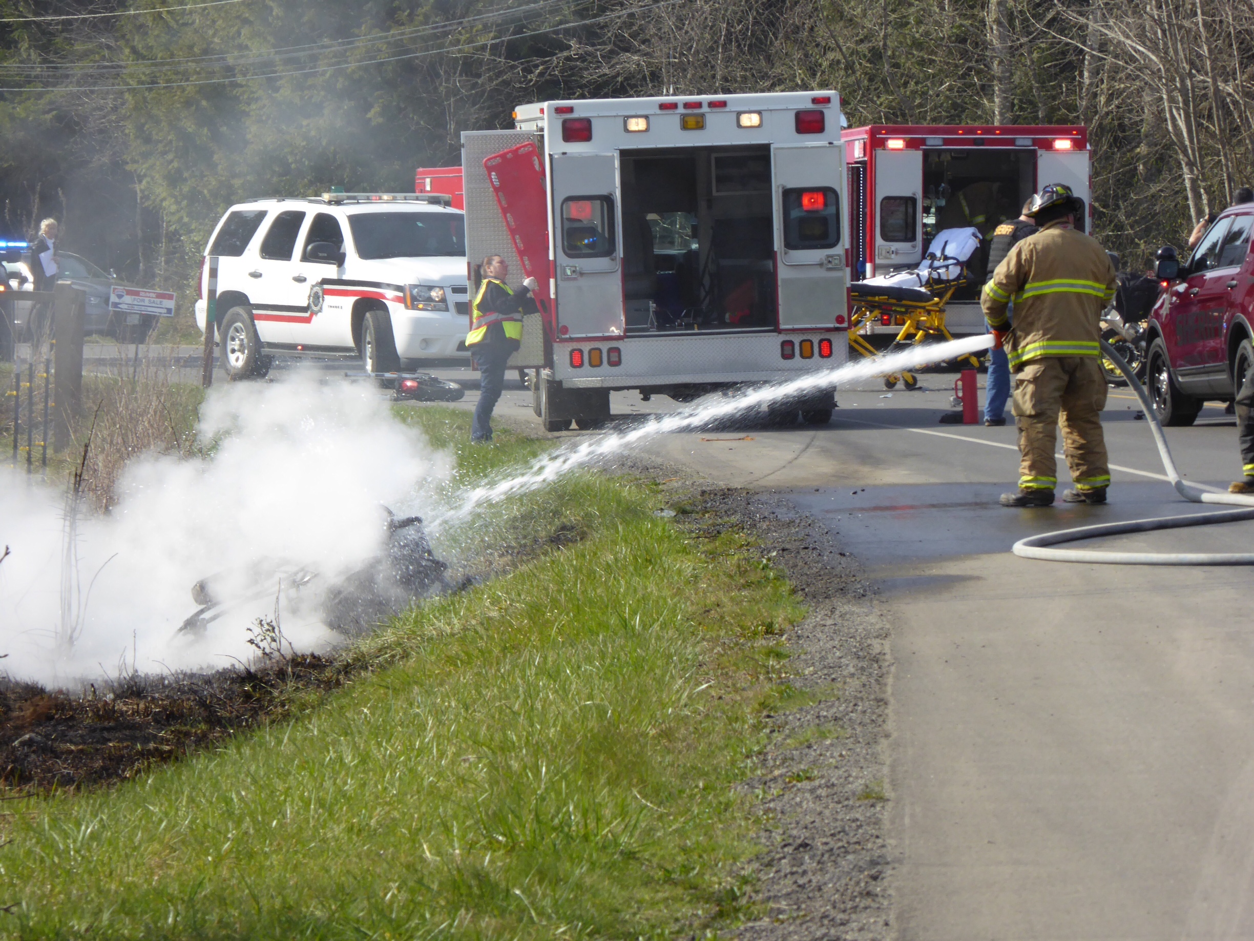 Firefighters put out a motorcycle fire after a wreck on Center Road this morning. (CharlieBermant/Peninsula Daiiy News)