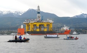 Protest boats approach the Polar Pioneer offshore oil platform and cargo deck ship Blue Marlin as they are hauled to their anchorage in Port Angeles Harbor. (Keith Thorpe/Peninsuila Daily News)