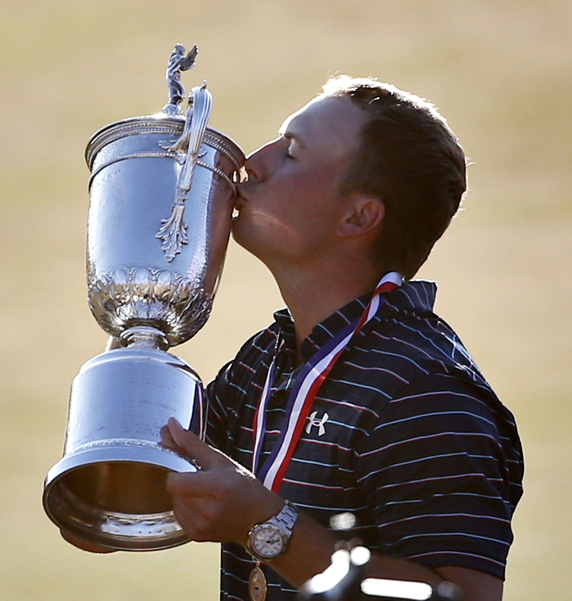 Jordan Spieth kisses the trophy after winning the the U.S. Open golf tournament at Chambers Bay on Sunday  in University Place. (The Associated Press)
