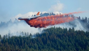 A DC-10 tanker airplane drops fire retardant on a wildfire north of Twisp in Okanogan County on Friday. The Associated Press (Click on image to enlarge)