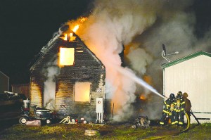 A fire burned an empty house and spread to a neighboring mobile home on South Brook Avenue east of Port Angeles on Wednesday night. Jay Cline/Clallam County Fire District 2