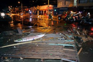 Police patrol a debris strewn street in Valparaiso