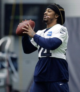 Seattle Seahawks running back Marshawn Lynch holds a candy cane in his mouth as he warms up before NFL football practice