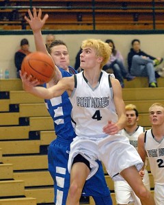 Port Angeles' Grayson Peet (4) goes for a layup against the defense of Lucas de Vries of St. Michaels University School of Victoria. Port Angeles' Nathan Angevine