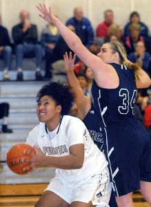 Peninsula's Tai Thomas ducks underneath the defense of Whatcom's Lindsey Honeycutt. (Keith Thorpe/Peninsula Daily News)