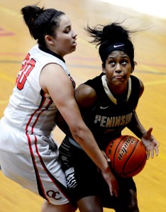 Peninsula College guard Imani Smith attacks the defense of Olympic's Eboni Harpes. (Rick Ross/Peninsula College Athletics)