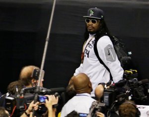 Seattle Seahawks' Marshawn Lynch leaves at the beginning of Media Day on Tuesday. (The Associated Press (Click on photo to enlarge))