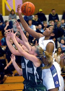 Sequim's Adrienne Haggerty rebounds the ball over Port Angeles' Maddie Boe